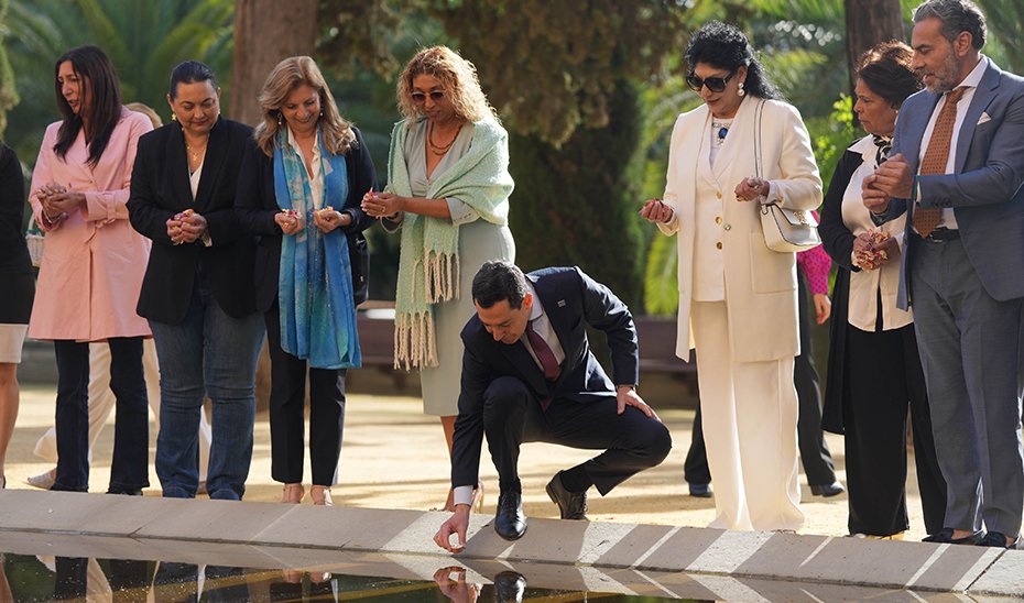 Moreno places a candle as an offering at the San Telmo Palace pond.